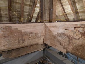 The carpenter repaired the cross beams with laminated oak boards